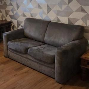 2 seater Grey color sofa-bed.