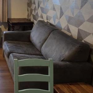 2 seater Grey color sofa-bed.